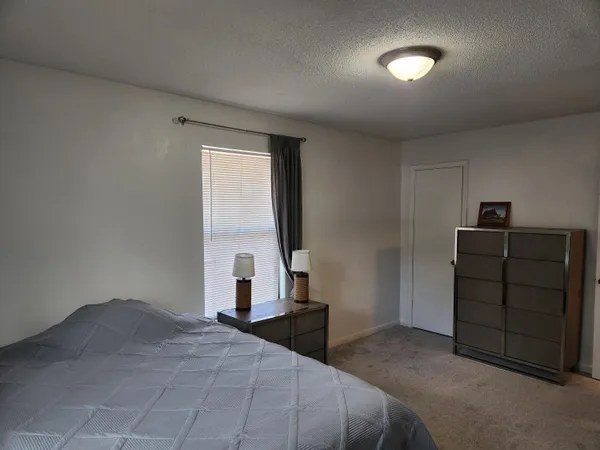 a bedroom with a bed and a dresser