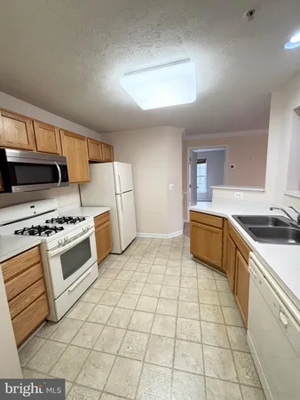a kitchen with a stove a sink and a refrigerator