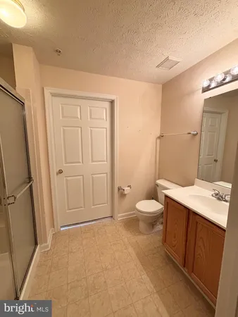 a bathroom with a sink a toilet and a large mirror