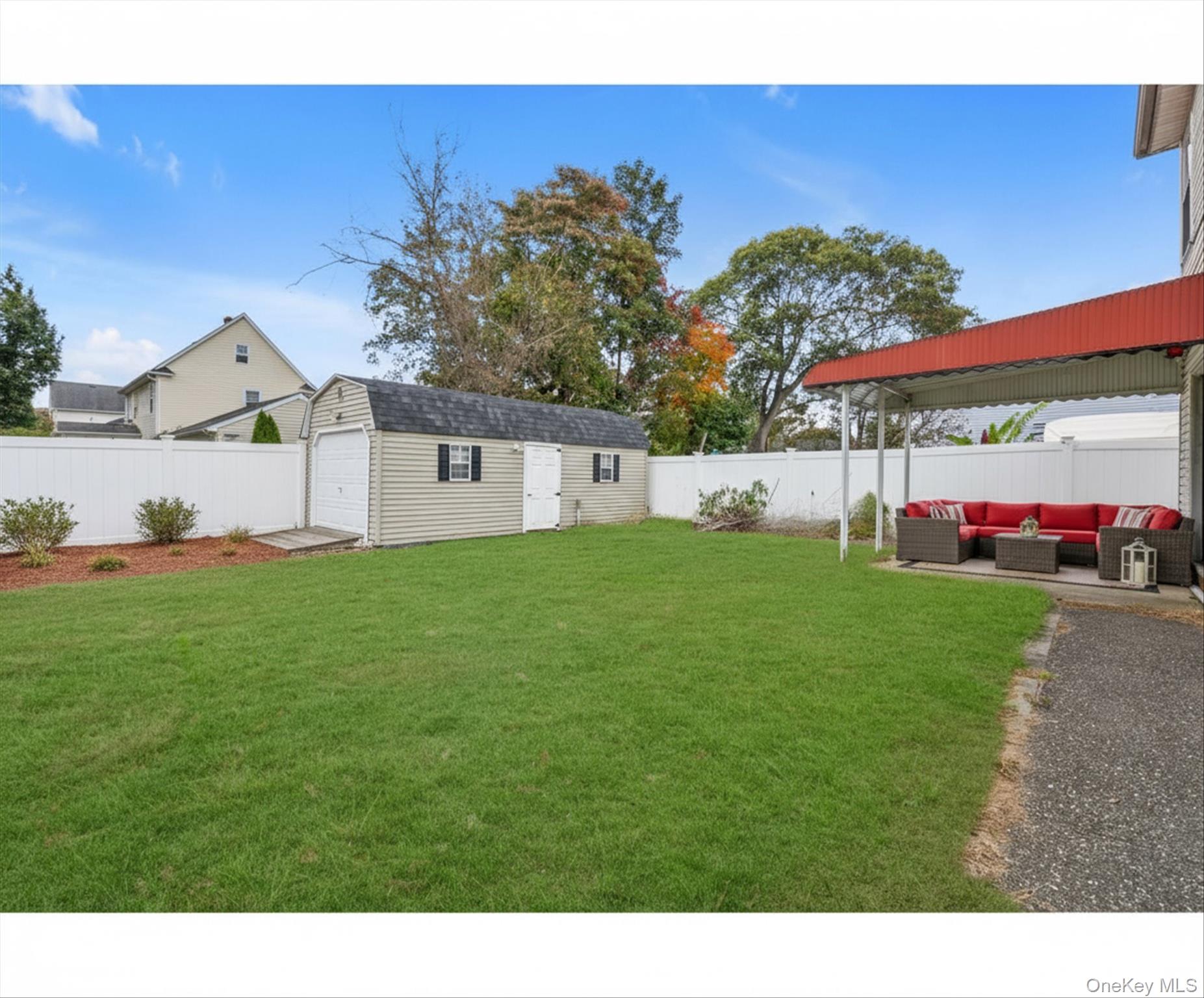 49 Prospect Street Roosevelt, NY 11575 - Photo 20 of 21 Virtually staged backyard (with furniture and landscaping)