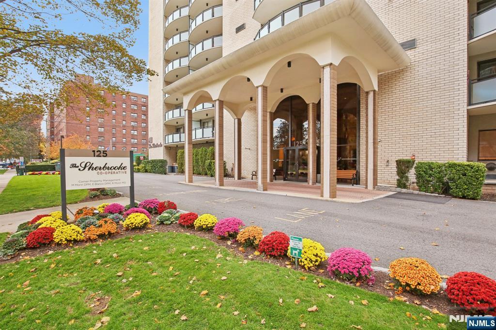 125 Prospect Avenue, Unit 17G Hackensack, NJ 07601 - Photo 1 of 30 a front view of multi story residential apartment building with yard