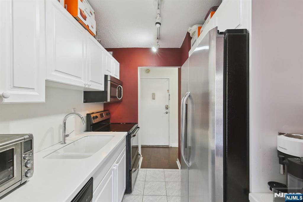 125 Prospect Avenue, Unit 17G Hackensack, NJ 07601 - Photo 14 of 30 a bathroom with a sink double vanity and a mirror