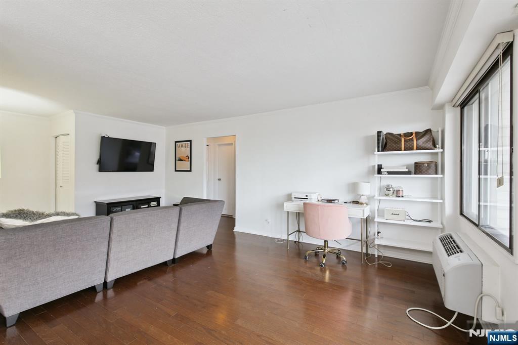 125 Prospect Avenue, Unit 17G Hackensack, NJ 07601 - Photo 19 of 30 a living room with furniture and a flat screen tv