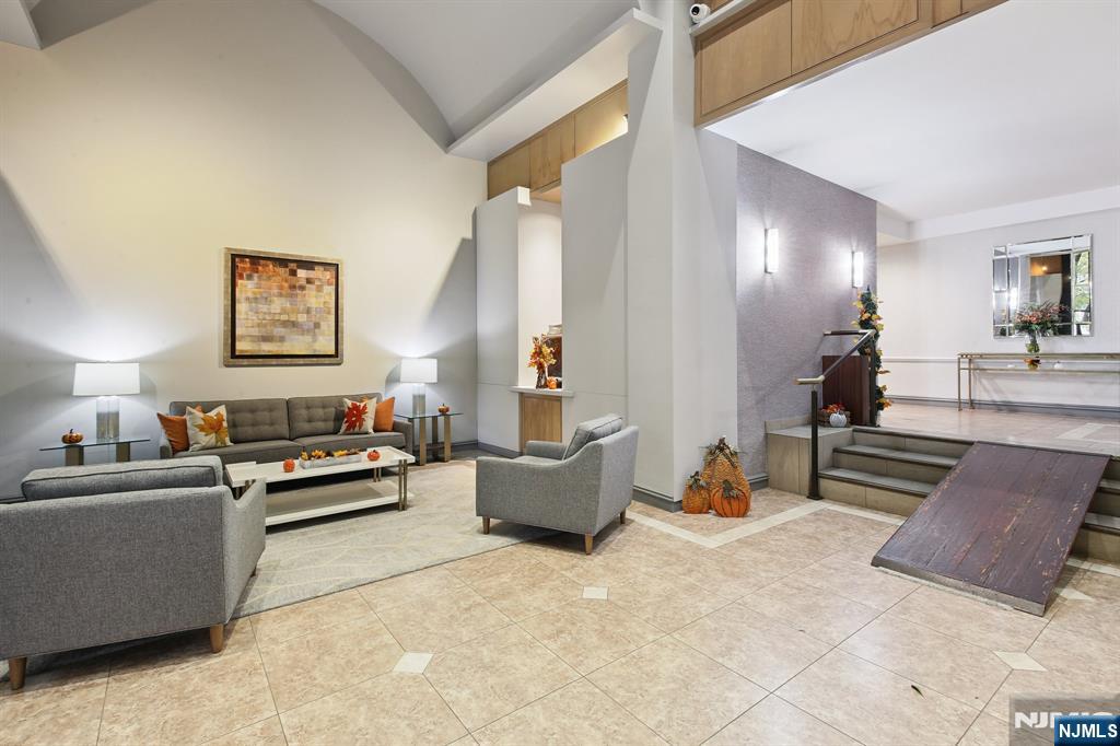 125 Prospect Avenue, Unit 17G Hackensack, NJ 07601 - Photo 28 of 30 a living room with furniture and wooden floor