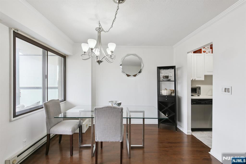 125 Prospect Avenue, Unit 17G Hackensack, NJ 07601 - Photo 8 of 30 a view of a dining room with furniture window and wooden floor