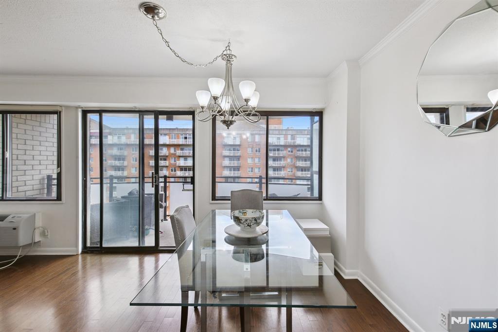 125 Prospect Avenue, Unit 17G Hackensack, NJ 07601 - Photo 9 of 30 a view of a dining room with furniture wooden floor and chandelier