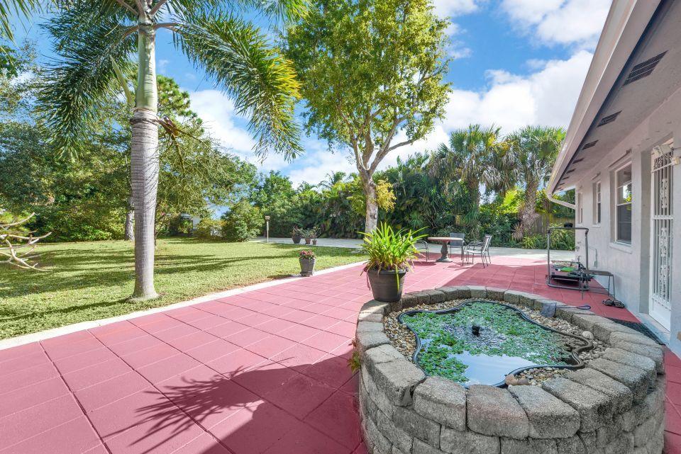 3196 Gulfstream Road Palm Springs, FL 33461 - Photo 16 of 26 a view of a backyard with a garden