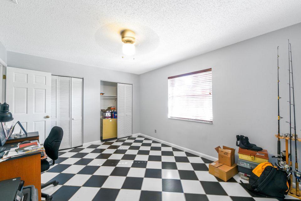 3196 Gulfstream Road Palm Springs, FL 33461 - Photo 20 of 26 a bedroom with a bed and a window