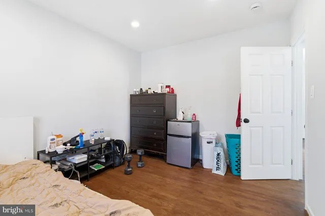a bedroom with furniture and a wooden floor