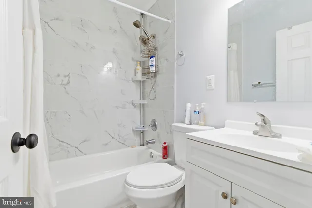 a bathroom with a sink toilet vanity and shower
