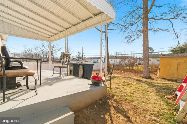 a building with pool table and chairs next to an umbrella