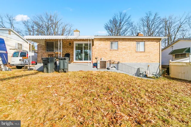 a front view of house with yard outdoor seating and barbeque oven