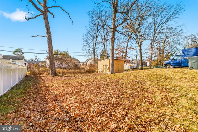a view of a yard with snow on the road