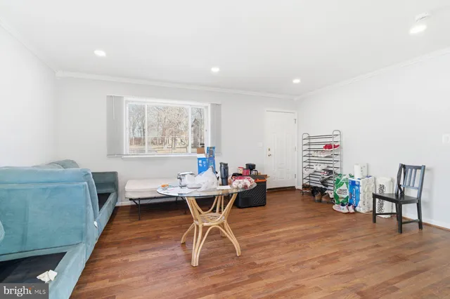 a workspace room with furniture wooden floor and a window