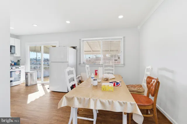 a dining room with a wooden table and chairs