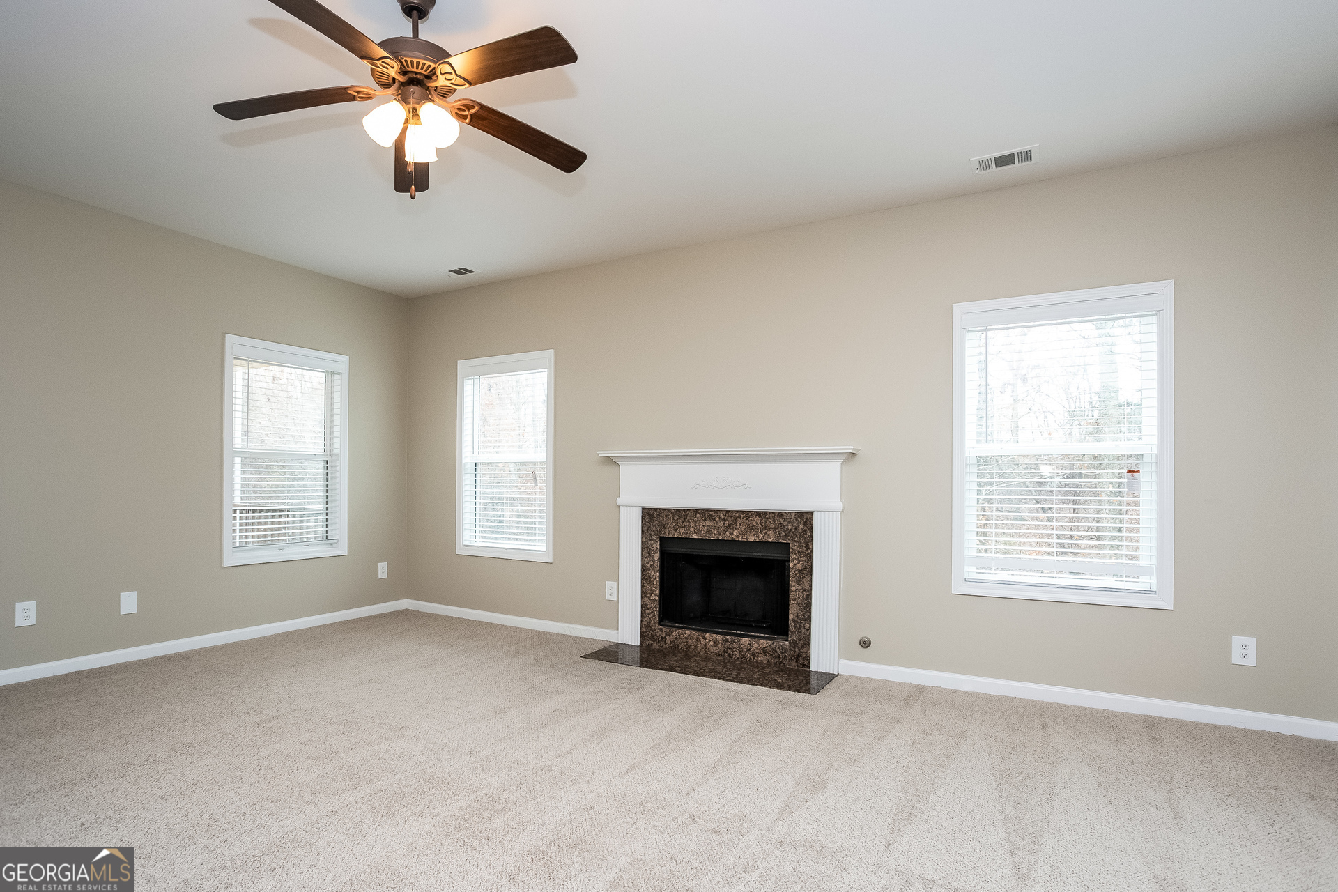 2729 Palmview Court Southwest Atlanta, GA 30331 - Photo 2 of 15 an empty room with windows and fireplace