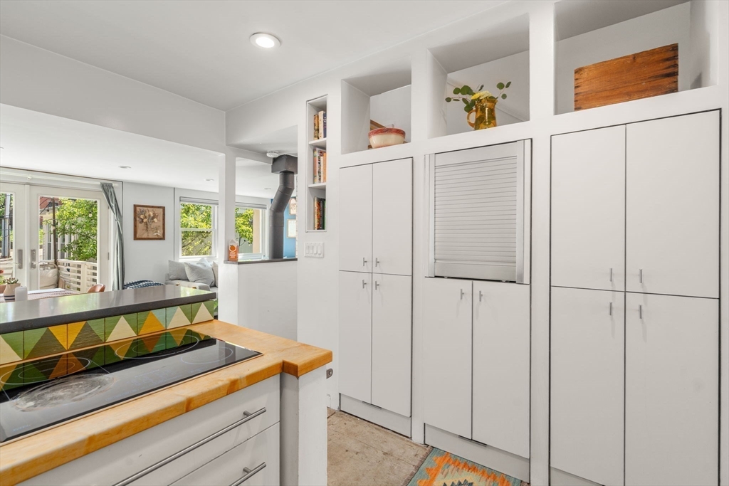 67 Dudley Street, Unit SF Boston, MA 02119 - Photo 10 of 28 a kitchen with white cabinets and white appliances