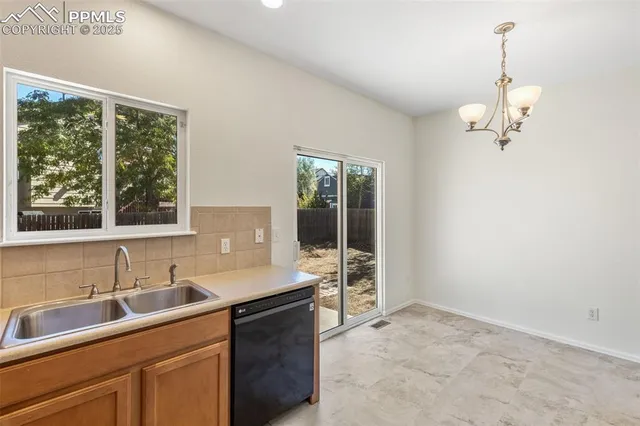 a kitchen with a sink cabinets and window