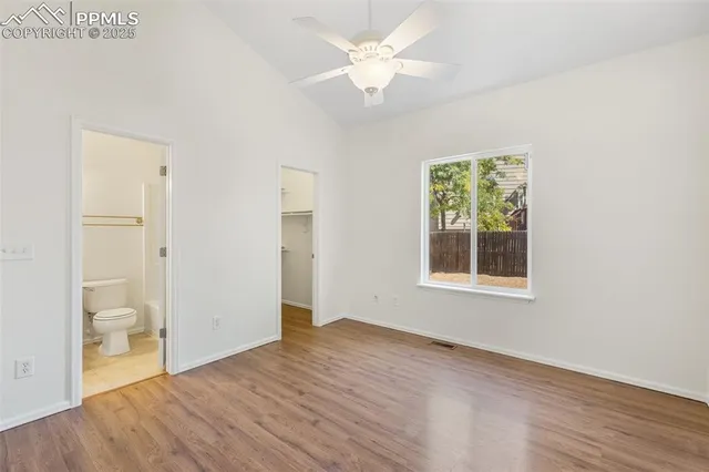 an empty room with a bathroom and a window