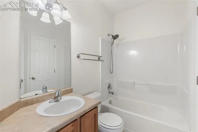 a bathroom with a granite countertop sink mirror toilet and bathtub