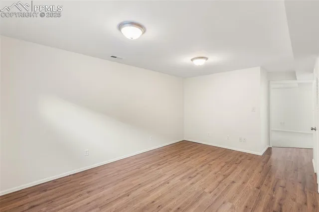 an empty room with wooden floor