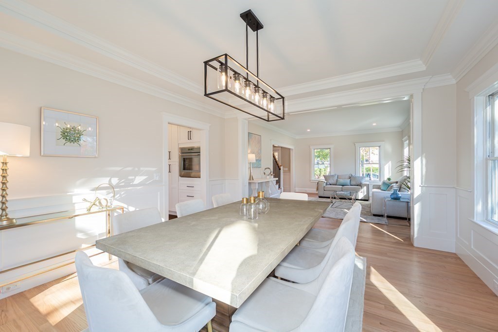 4 Whitcomb Street Natick, MA 01760 - Photo 11 of 42 a view of a dining room and livingroom with furniture wooden floor a chandelier