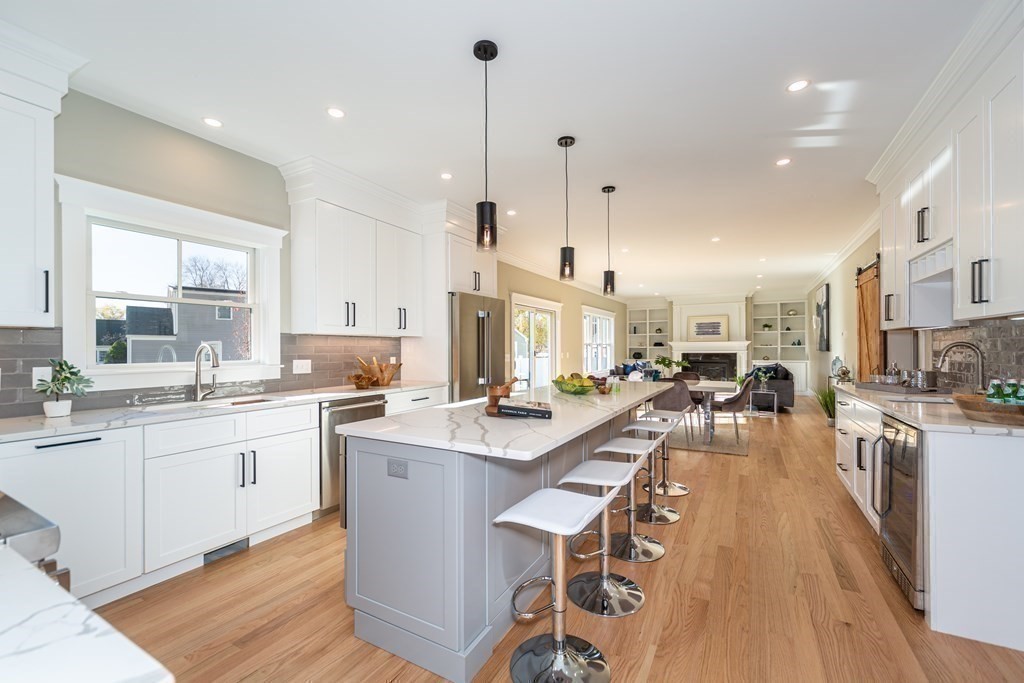 4 Whitcomb Street Natick, MA 01760 - Photo 14 of 42 a large kitchen with kitchen island a sink a center island stainless steel appliances and a center island