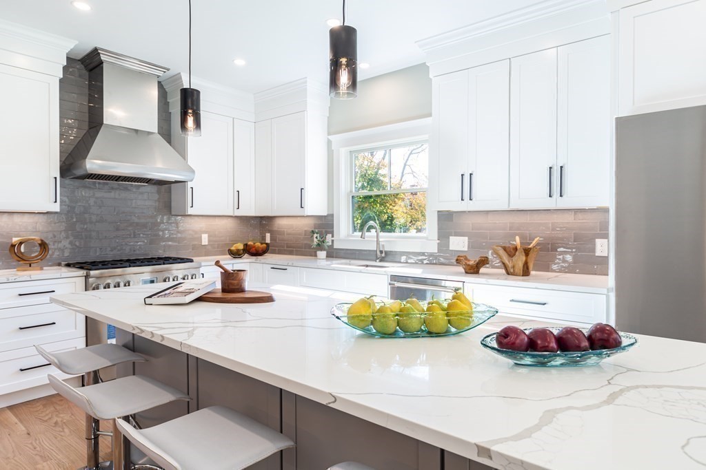 4 Whitcomb Street Natick, MA 01760 - Photo 17 of 42 a kitchen with a sink a stove and chairs