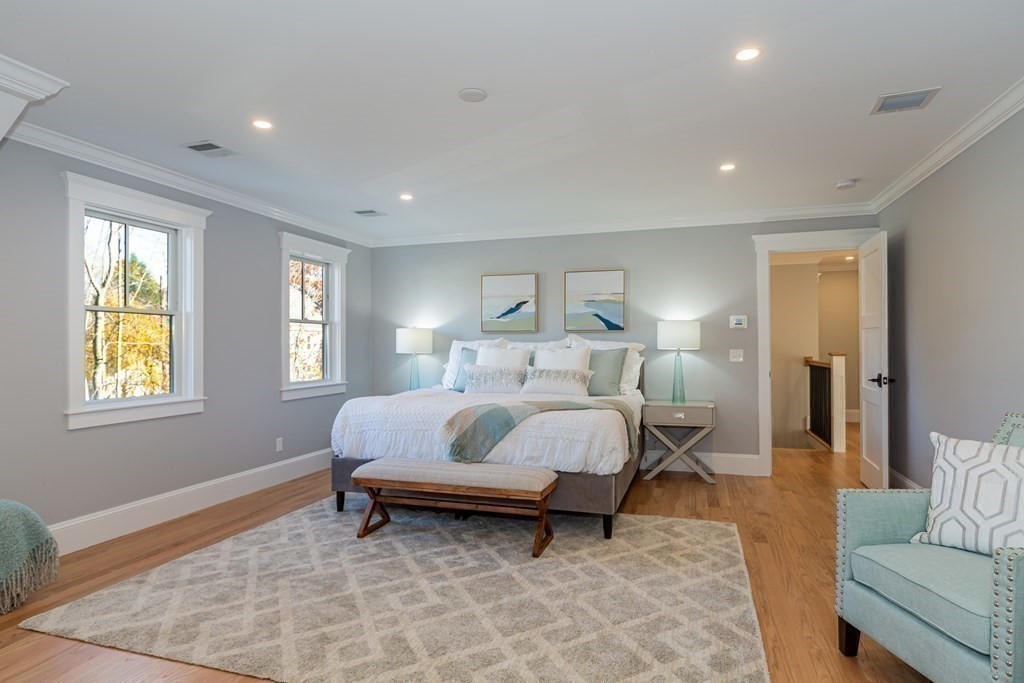 4 Whitcomb Street Natick, MA 01760 - Photo 22 of 42 a spacious bedroom with a bed and wooden floor