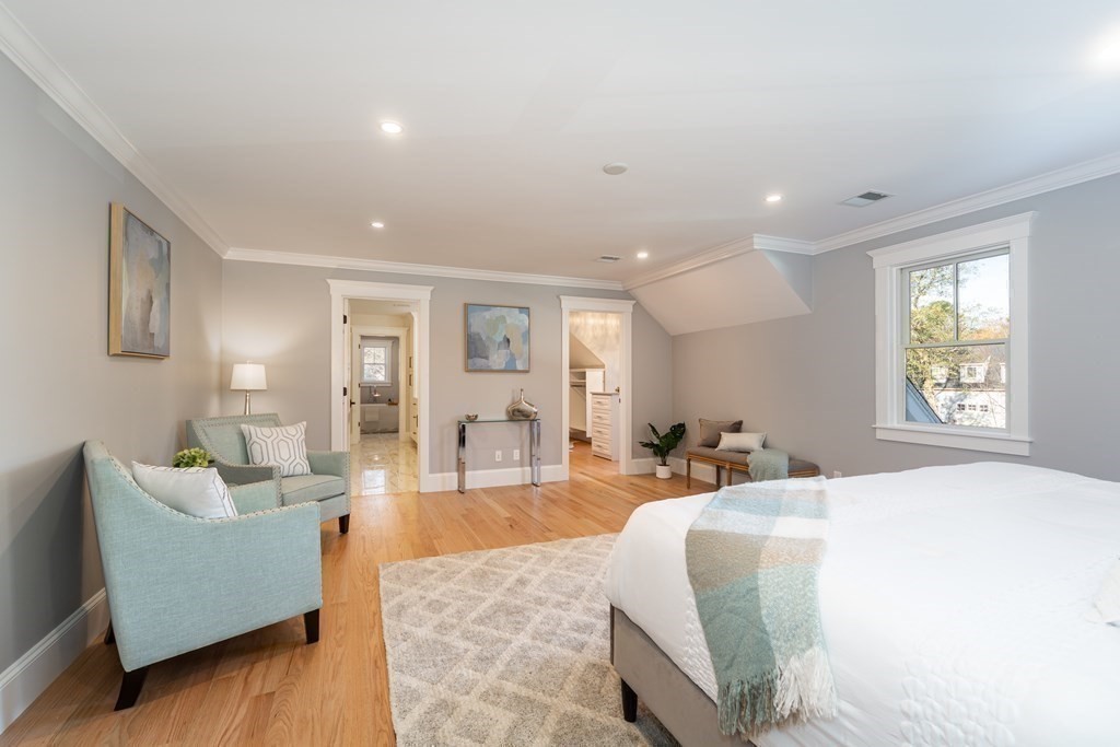 4 Whitcomb Street Natick, MA 01760 - Photo 23 of 42 a spacious bedroom with a bed a couch and a window