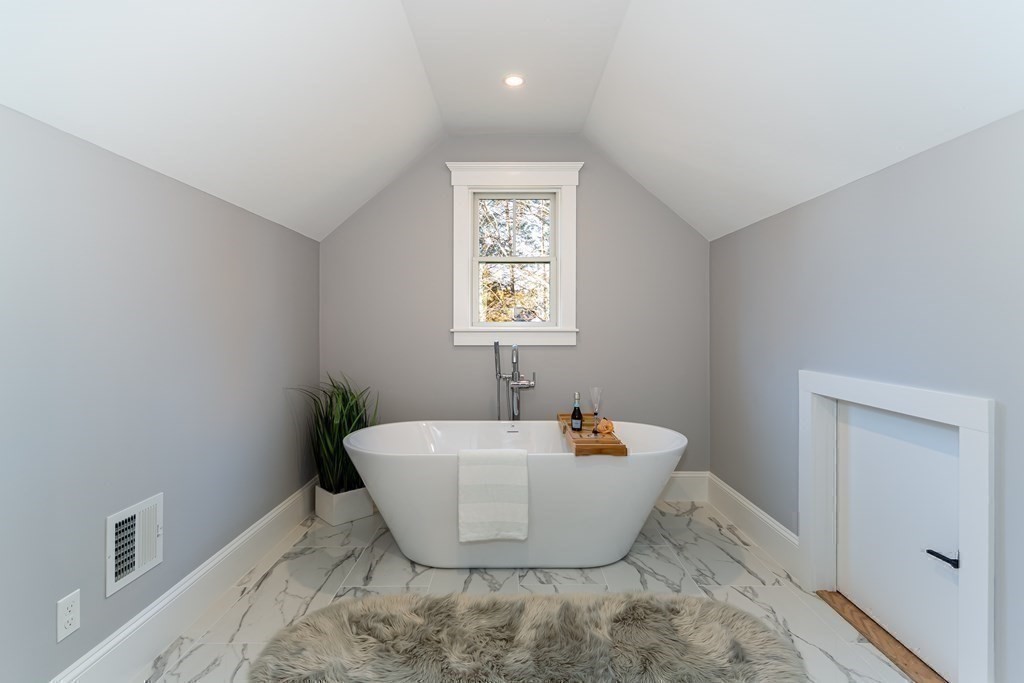 4 Whitcomb Street Natick, MA 01760 - Photo 27 of 42 a white bath tub sitting in a bathroom