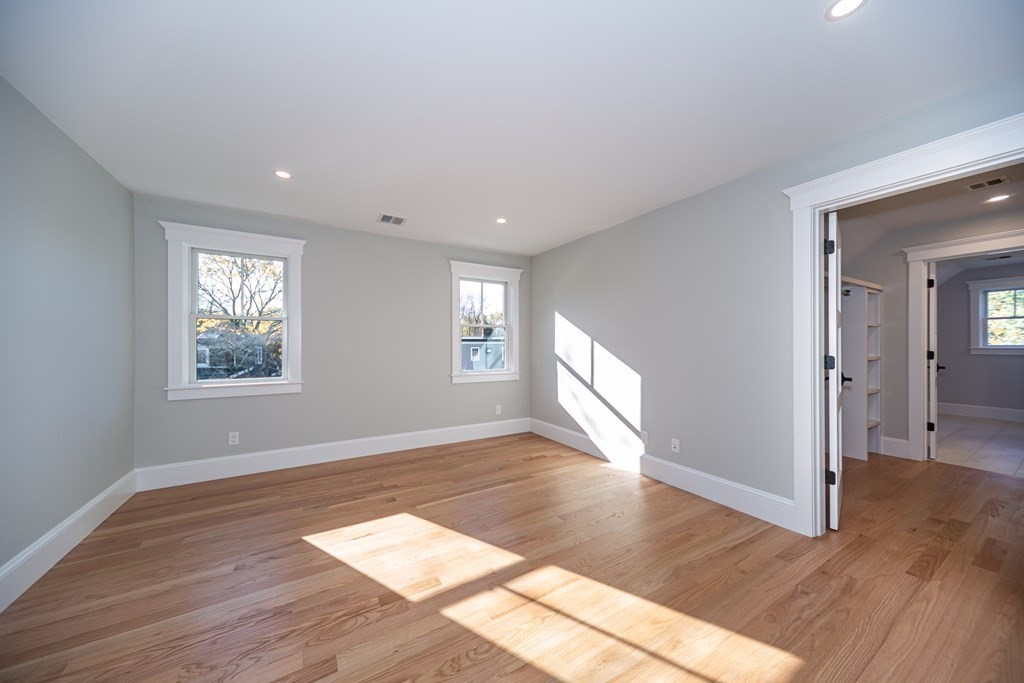 4 Whitcomb Street Natick, MA 01760 - Photo 30 of 42 an empty room with wooden floor and windows