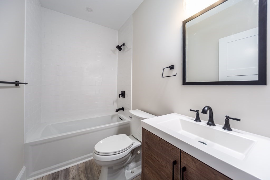 4 Whitcomb Street Natick, MA 01760 - Photo 37 of 42 a bathroom with a sink a toilet and shower