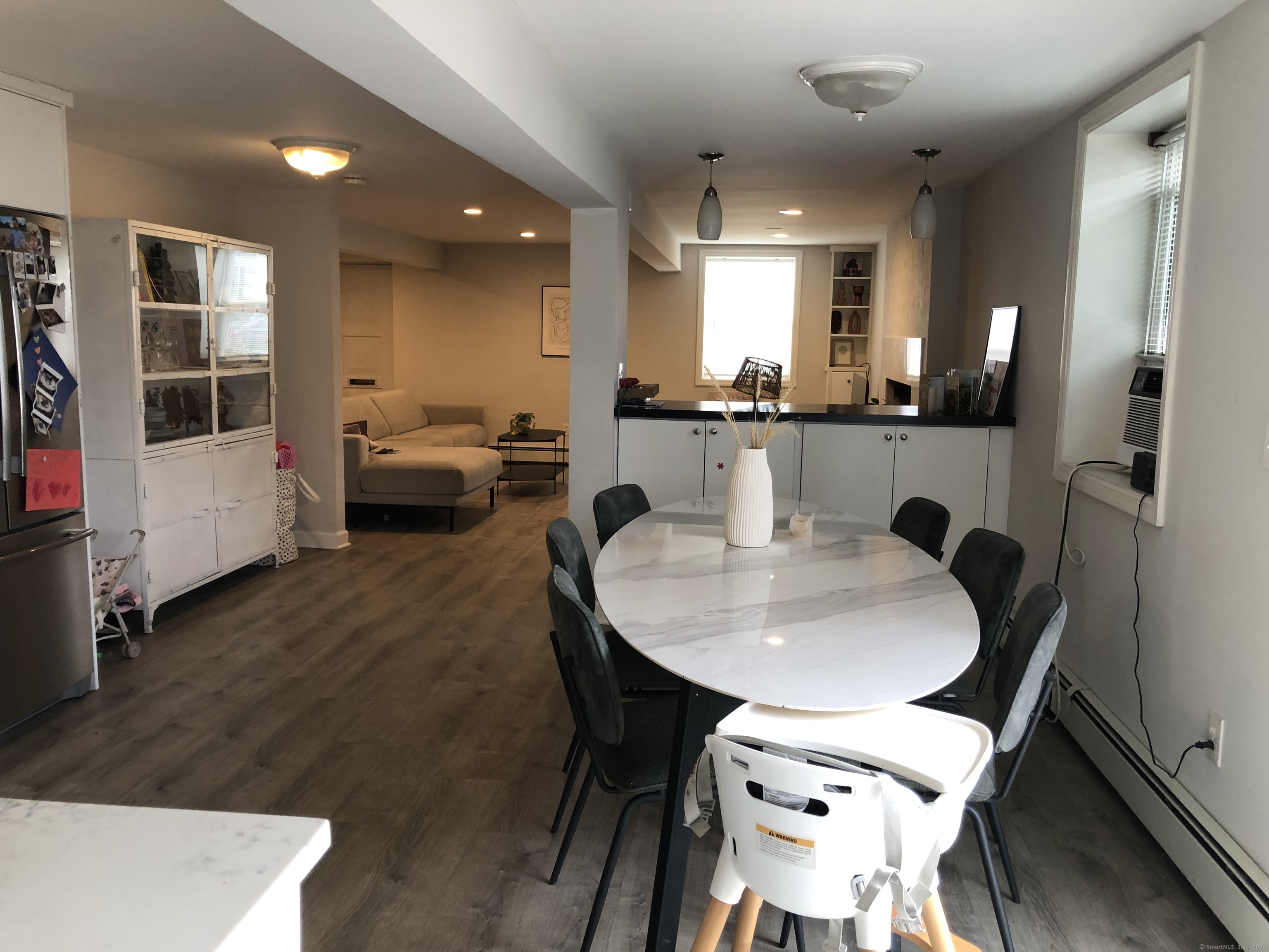 90 Iroquois Road, Unit A Stamford, CT 06902 - Photo 2 of 19 a dining room with furniture and wooden floor