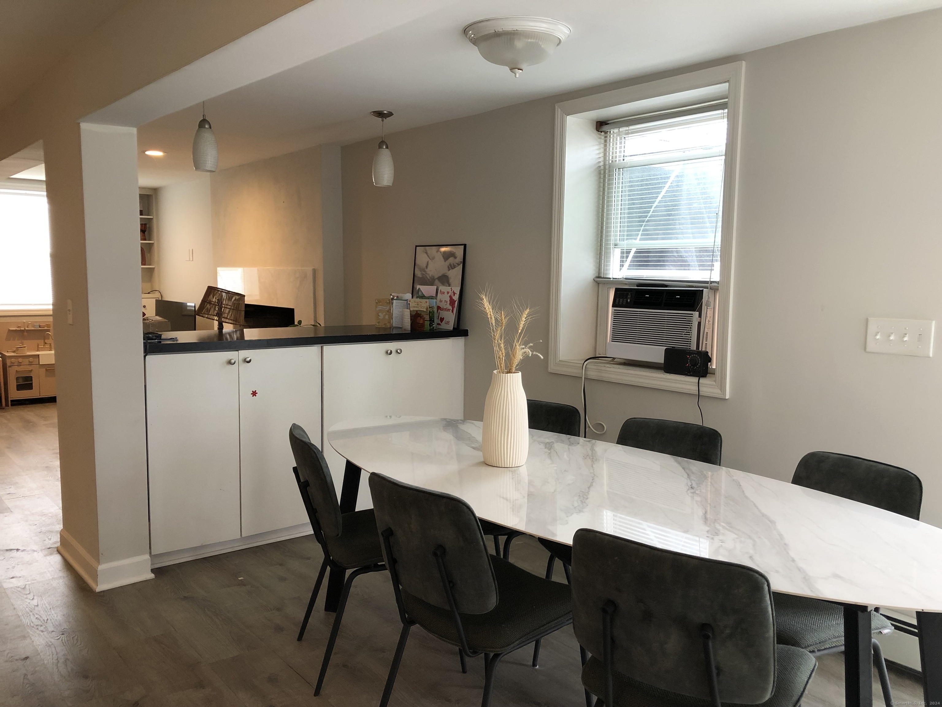 90 Iroquois Road, Unit A Stamford, CT 06902 - Photo 7 of 19 a kitchen with a dining table chairs and refrigerator