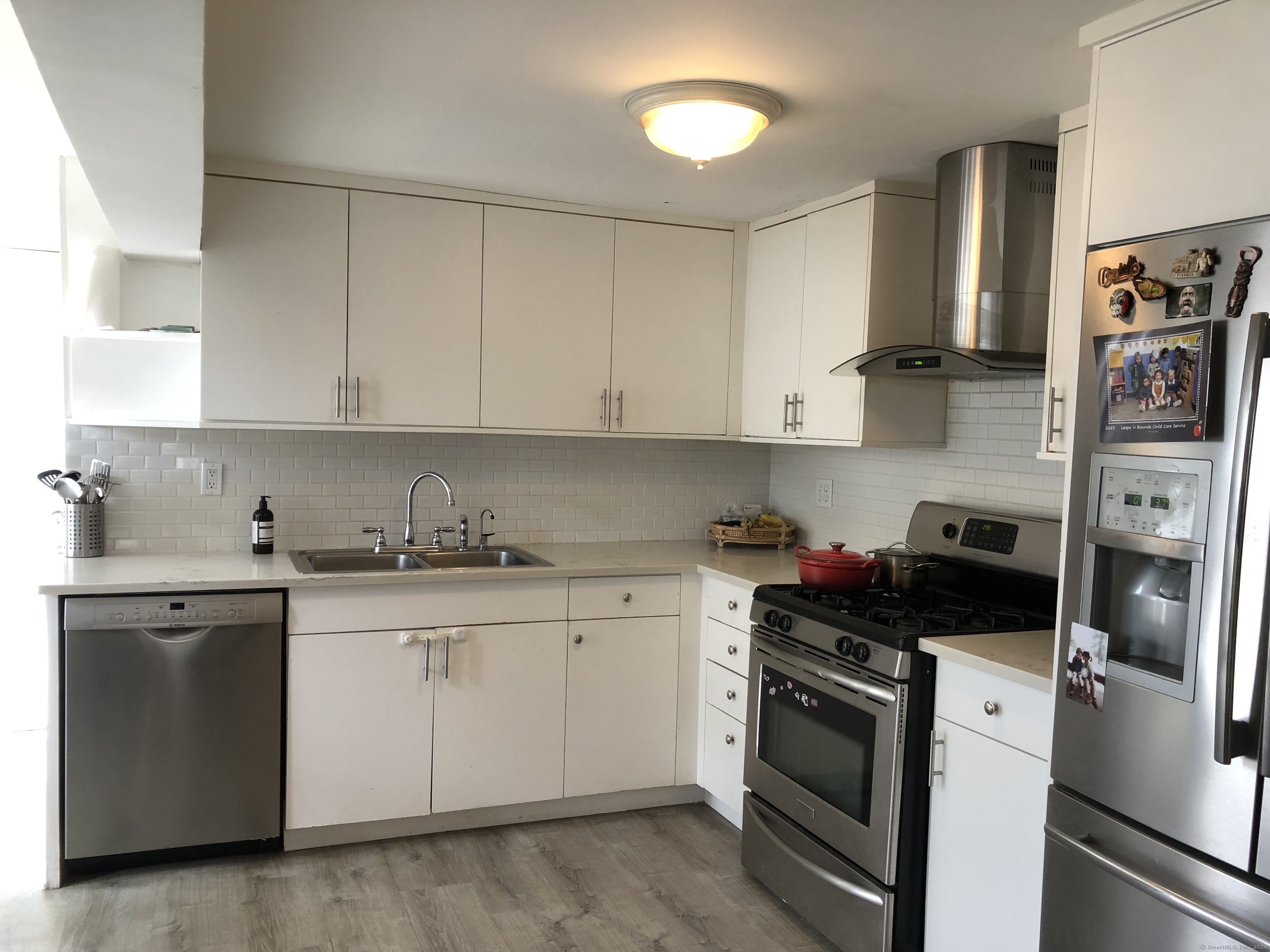 90 Iroquois Road, Unit A Stamford, CT 06902 - Photo 8 of 19 a kitchen with stainless steel appliances granite countertop a stove a sink and a refrigerator