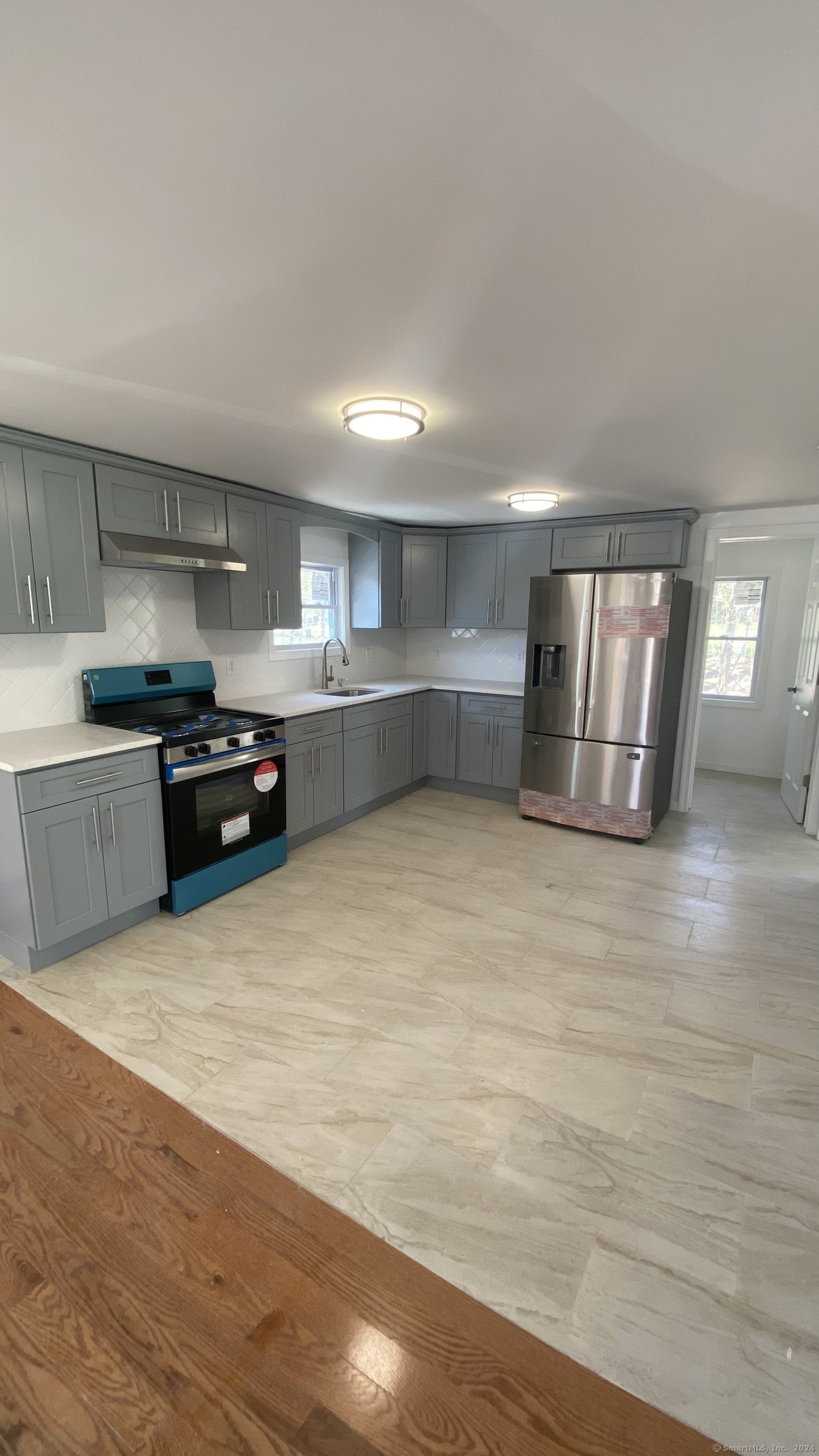 a kitchen with granite countertop a stove and cabinets
