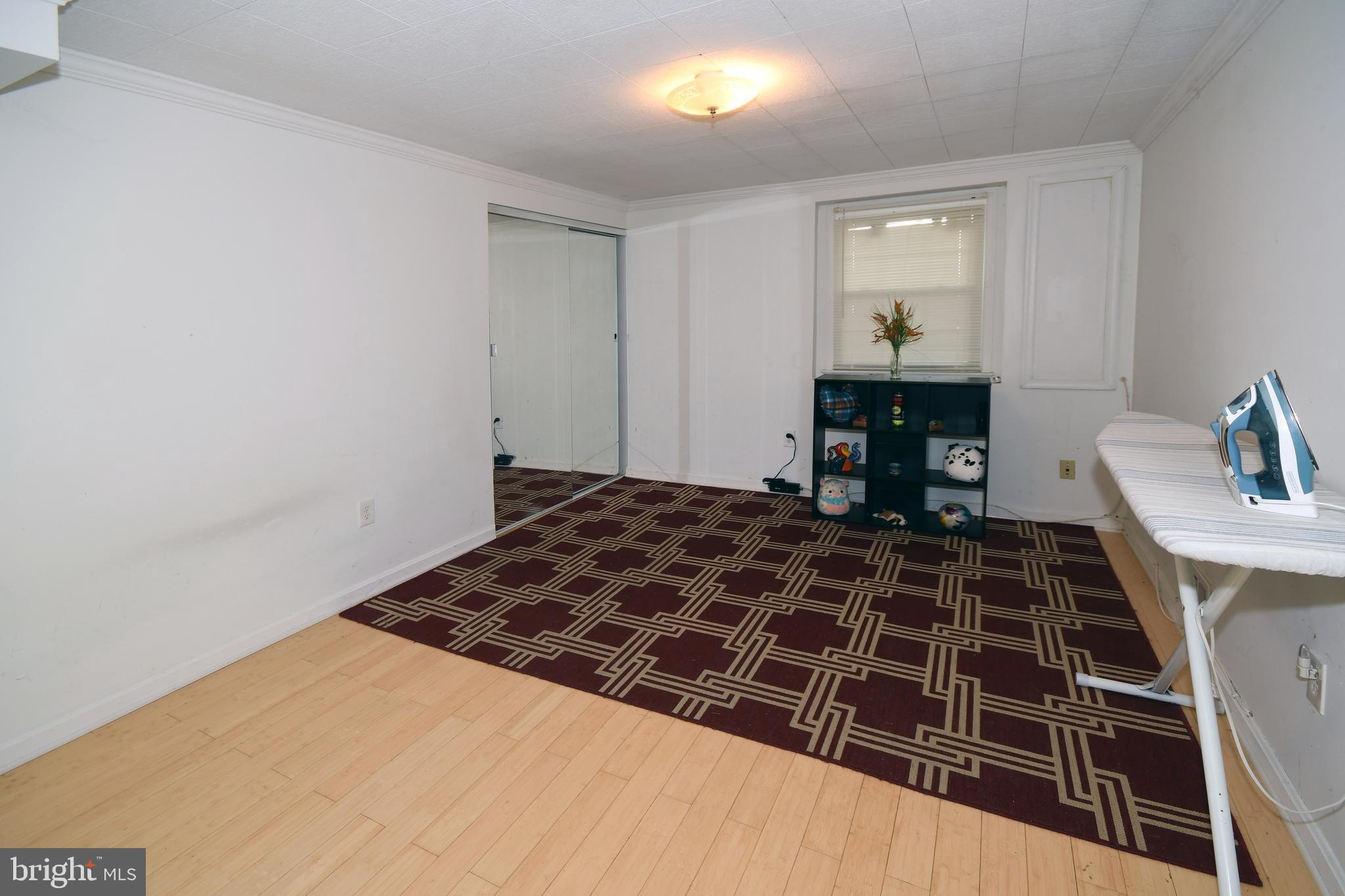 1402 Mullins Street Silver Spring, MD 20904 - Photo 17 of 29 a bedroom with a bed and a stove top oven