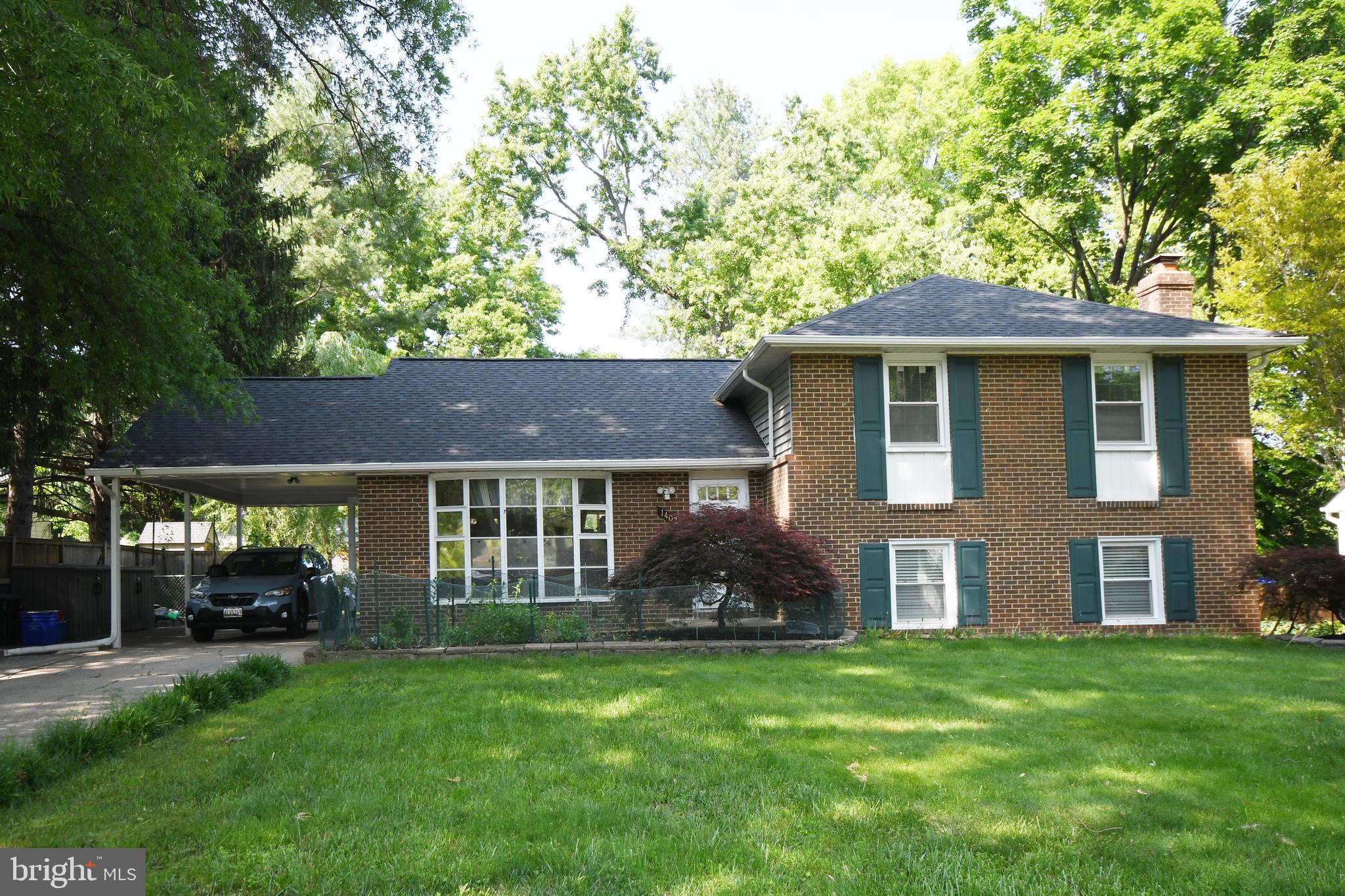 1402 Mullins Street Silver Spring, MD 20904 - Photo 23 of 29 a front view of a house with a garden