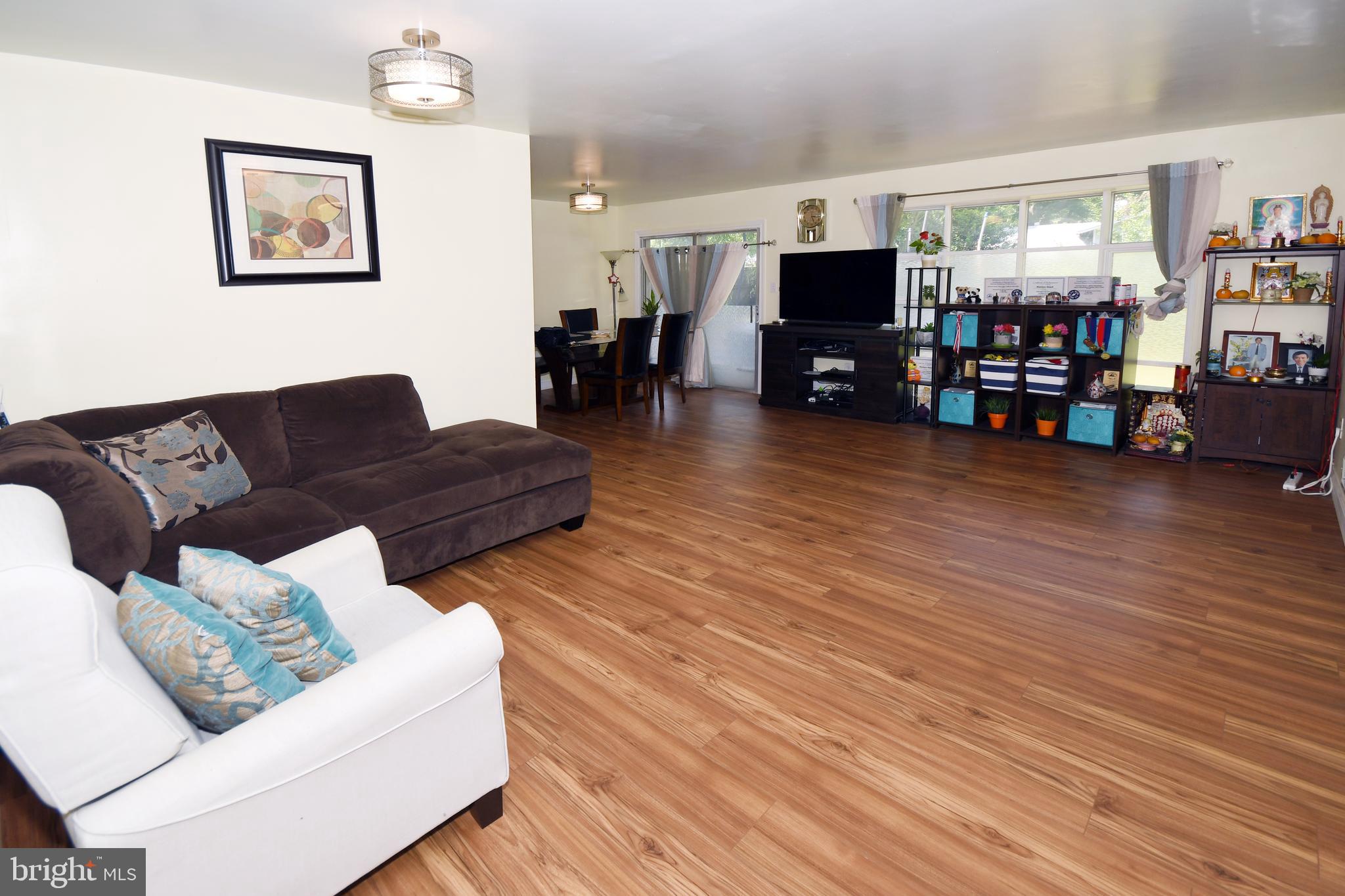 1402 Mullins Street Silver Spring, MD 20904 - Photo 4 of 29 a living room with furniture and a flat screen tv
