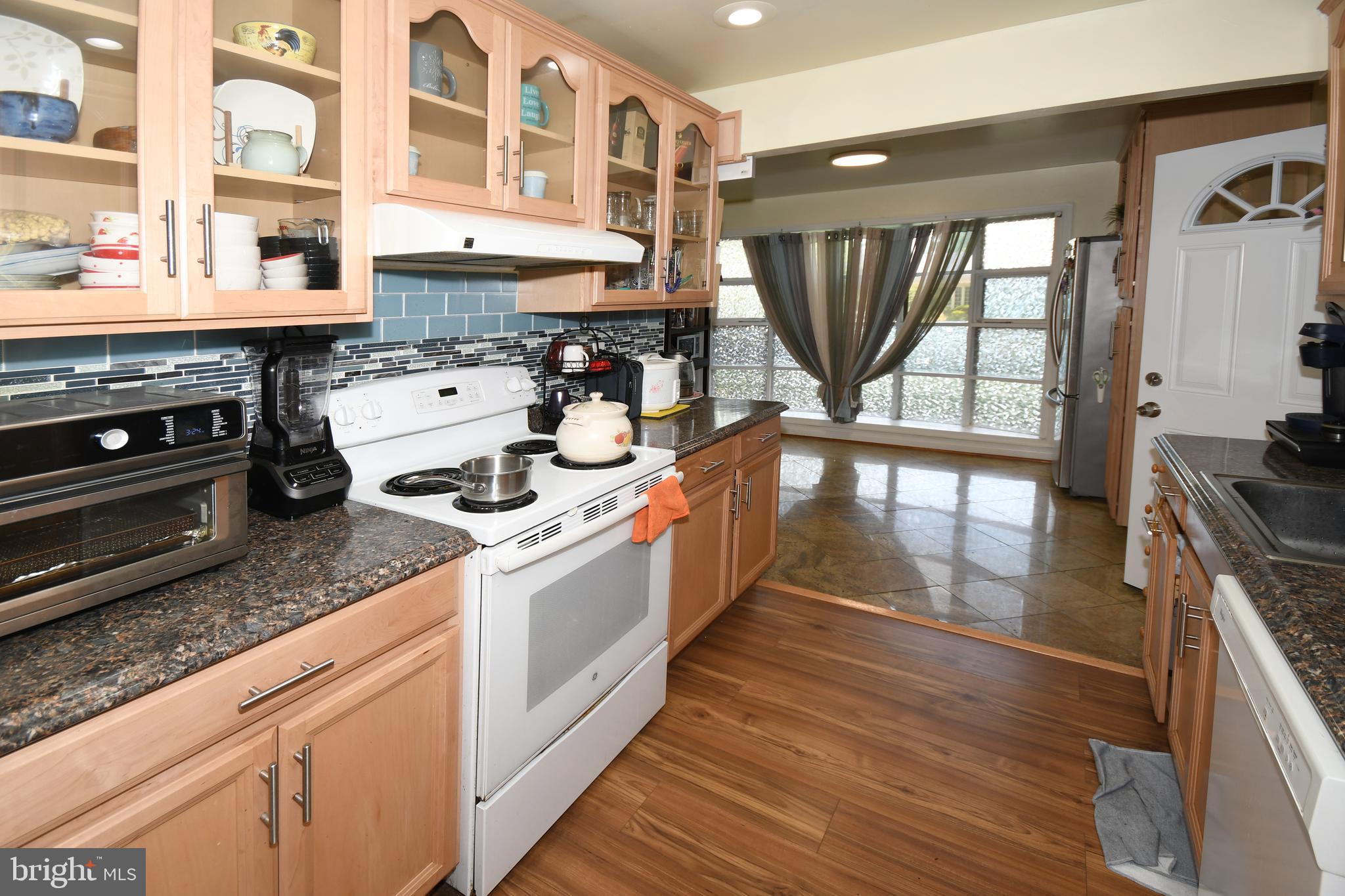 1402 Mullins Street Silver Spring, MD 20904 - Photo 7 of 29 a kitchen with a stove a sink and a wooden floor