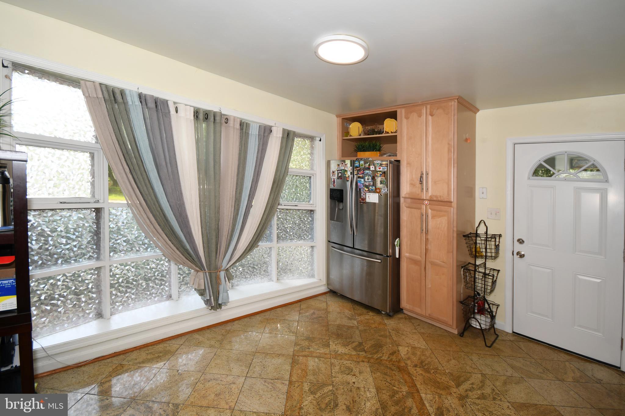 1402 Mullins Street Silver Spring, MD 20904 - Photo 9 of 29 a view of a refrigerator in kitchen and an empty room