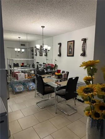 a living room with lots of furniture and a chandelier