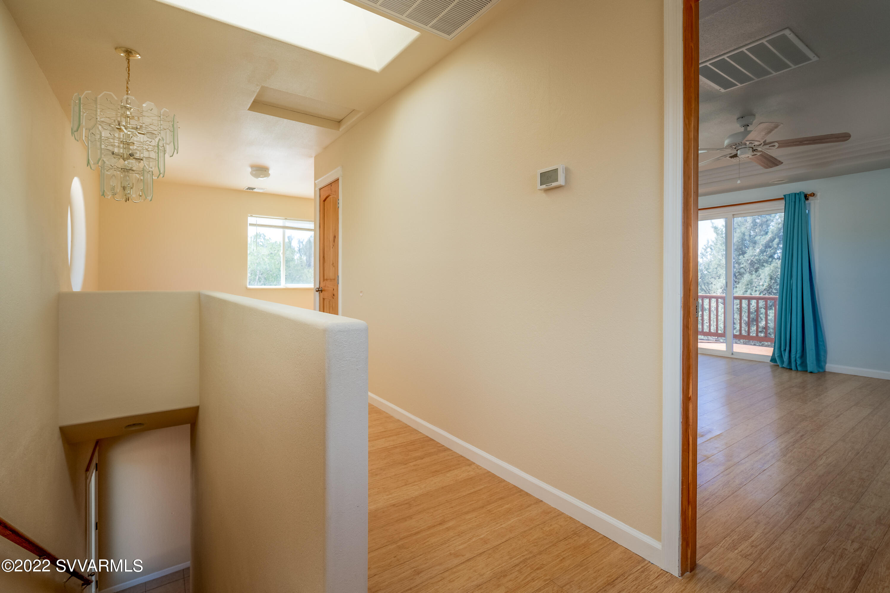 4455 Eagles Roost Road Rimrock, AZ 86335 - Photo 11 of 31 a view of a hallway with wooden floor and a living room