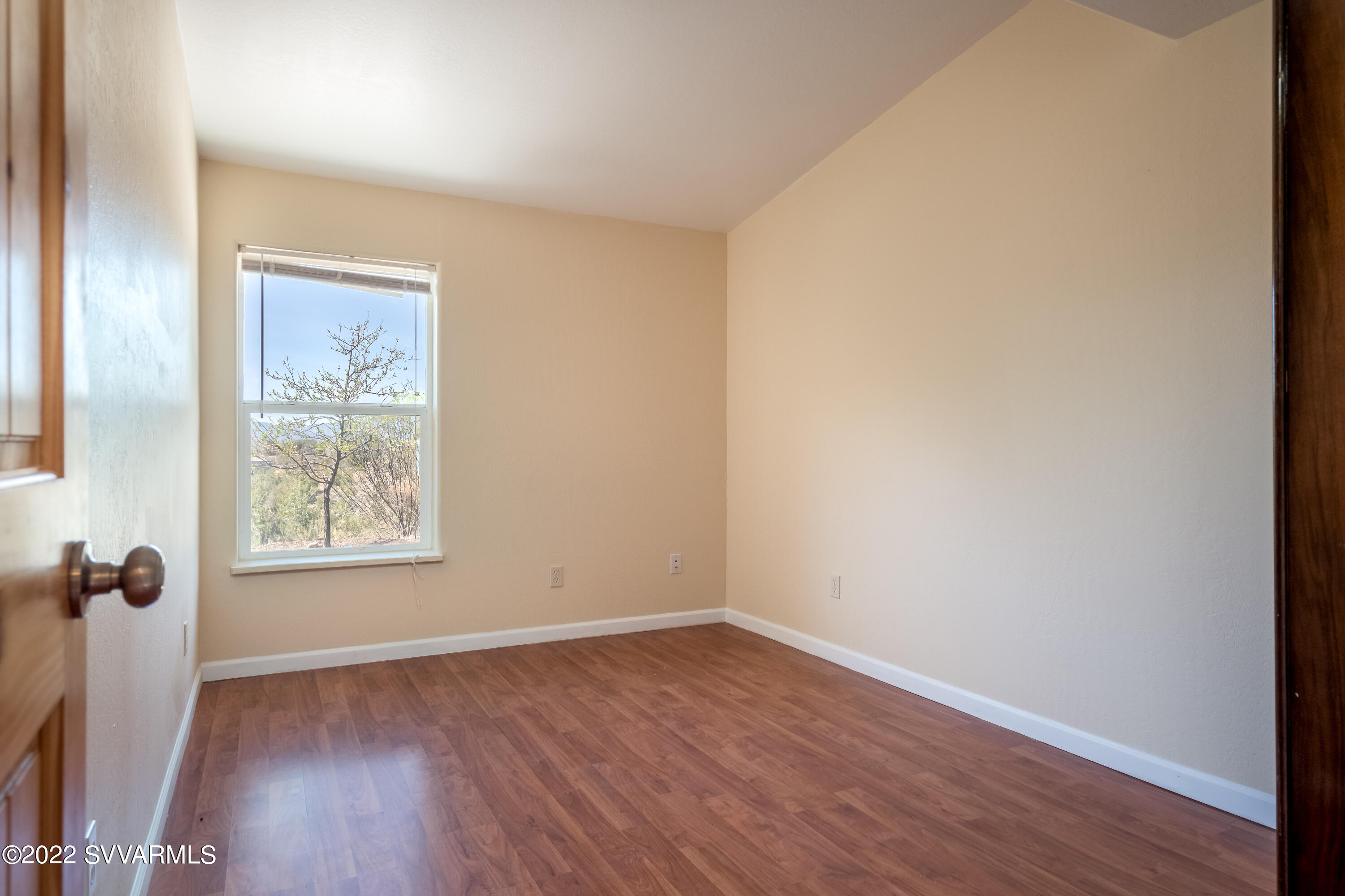 4455 Eagles Roost Road Rimrock, AZ 86335 - Photo 16 of 31 an empty room with wooden floor and windows