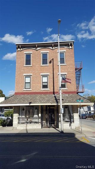 274 Main Street, Unit 3 Beacon, NY 12508 - Photo 1 of 1 a front view of building with streets and trees