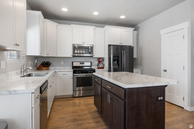 5155 East Rio Grande Way Eagle Mountain, UT 84005 - Photo 11 of 40 Kitchen with stainless steel appliances, two tone color scheme, a center island, dark wood-style flooring, and recessed lighting