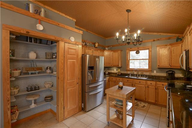 396 Pee Dee Branch Road, Unit 396B Cottontown, TN 37048 - Photo 6 of 20 The Kitchen adorns Customized Oak Cabinets, Double Pantry, New Stainless Steel Appliances and Open Shelving to display extra Kitchen items.