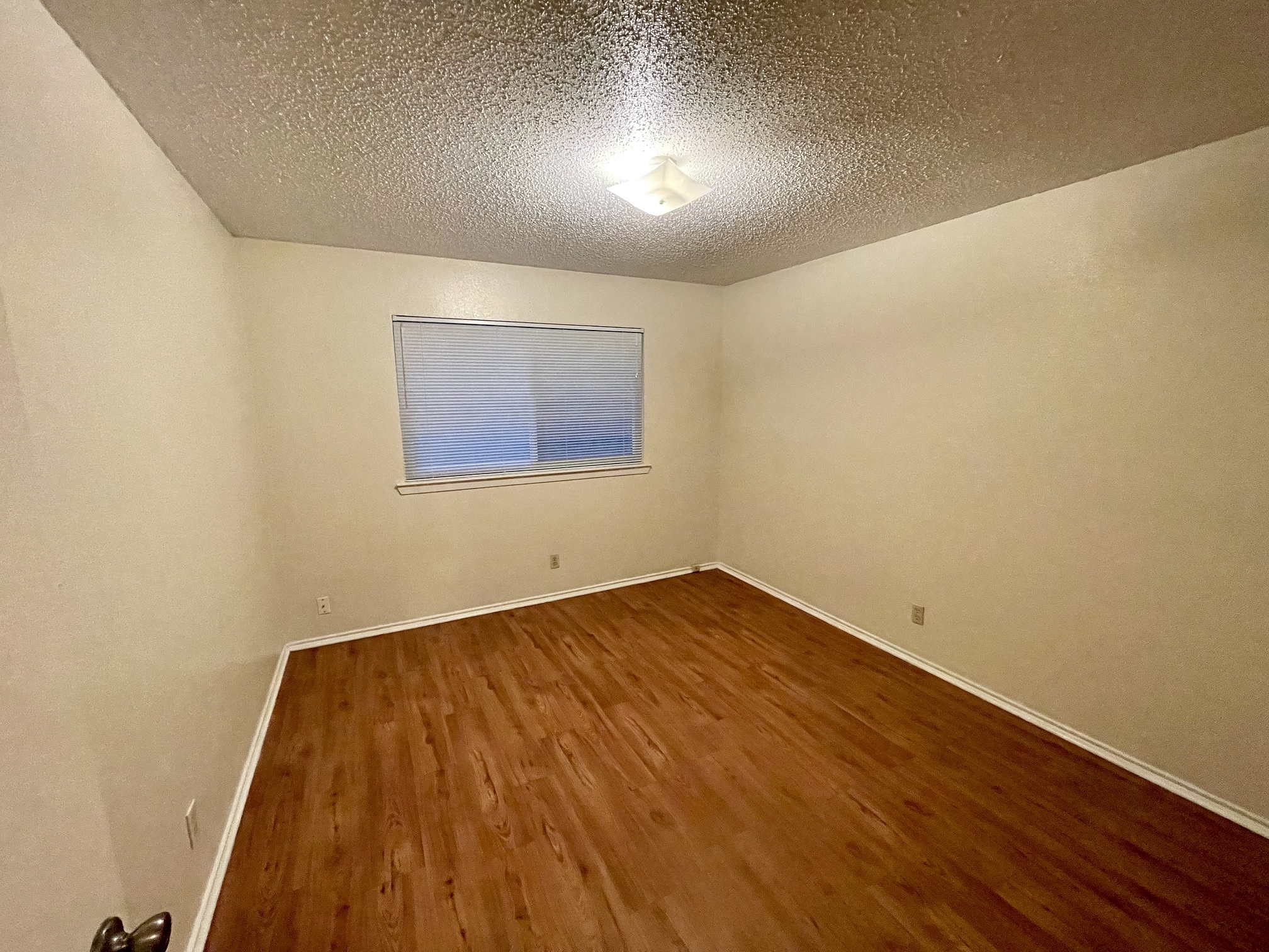 10003 Parliament House Road Austin, TX 78717 - Photo 9 of 31 an empty room with wooden floor and windows