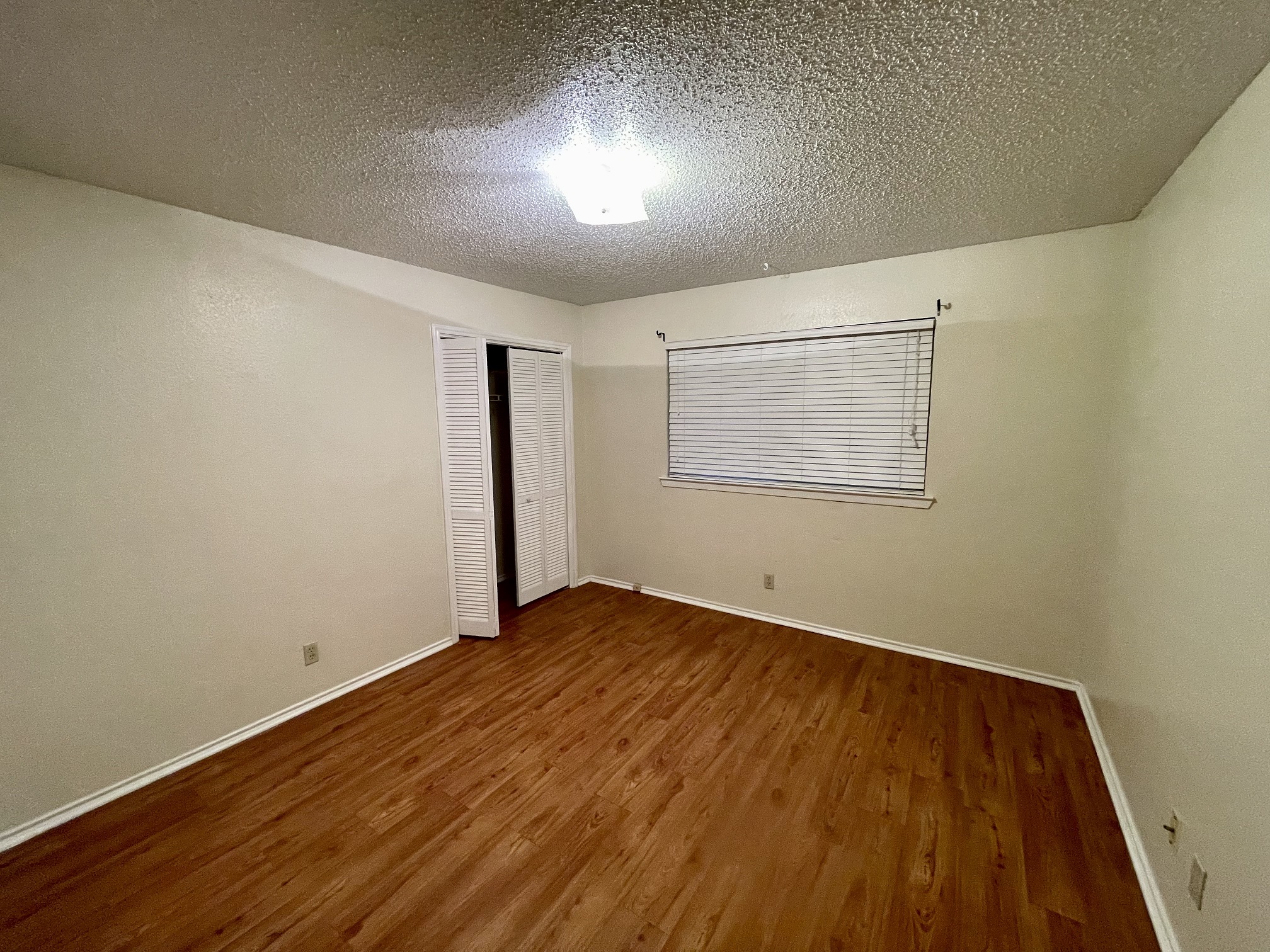 10003 Parliament House Road Austin, TX 78717 - Photo 11 of 31 an empty room with wooden floor and windows